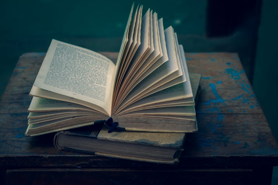 An open vintage book on a rustic wooden table, evoking a sense of nostalgia and wisdom.
