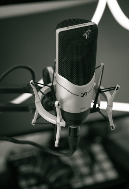 Close-up of a sleek microphone setup in a modern recording studio, capturing sound with precision.